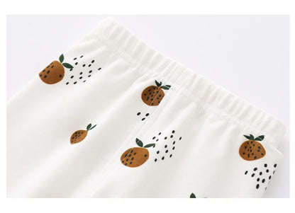 Detail van baby legging van biologisch katoen met elastische tailleband en fruitige print in oranje tinten